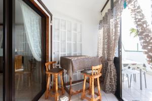 a room with two chairs and a table on a balcony at Apartment direkt am Meer in Costa Del Silencio