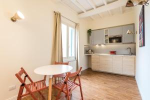 a kitchen with a table and two chairs in a room at Dimora Sant'Orsola in Florence