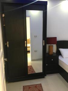 a mirror in a room with a bed and a bed sqor at Pool View One bedroom Apt - B103 in Hurghada