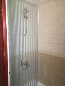 a shower with a glass door in a bathroom at Pool View One bedroom Apt - B103 in Hurghada