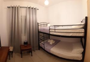 two bunk beds in a small room with a window at Skala Pearls A2 in Skala Kefalonias