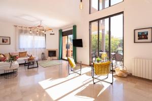 a living room with yellow chairs and a couch at VILLA WINE EXPERIENCE Salou Center - SPA & Wine in Salou