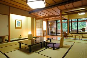 a living room with a couch and a table at Enraku in Kurobe