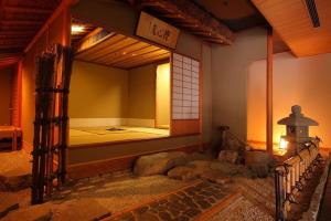 a room with a bed in the corner of a building at Enraku in Kurobe