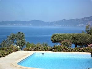 a swimming pool with a view of the water at Hotel Celine in Coti-Chiavari