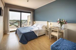 Postel nebo postele na pokoji v ubytování Hotel Marina Uno