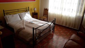 a bedroom with a bed in a room with a window at Casa Mirella in Bolsena
