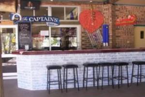 a bar with four bar stools in a restaurant at Halliday Bay Resort in Seaforth