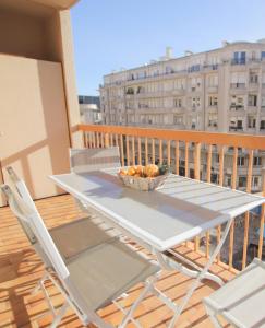 a table on a balcony with a bowl of fruit at Le Renoir in Nice