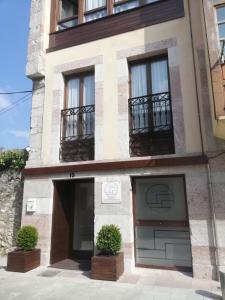 a building with two garage doors and two windows at El Cantil in Llanes