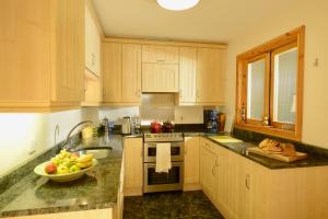 a kitchen with a bowl of fruit on the counter at Oakfield B&B in Lisburn