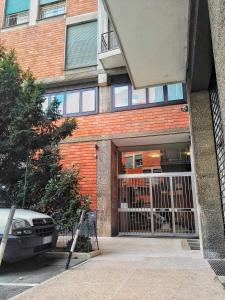 a car parked in front of a building with a gate at Central City Rooms Executive Suite in Bologna