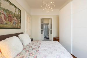 a bedroom with a bed and a painting on the wall at Palazzo BellaVista by Impero House in Stresa