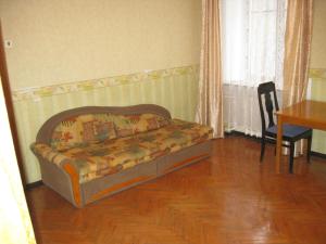 a couch in a living room with a table and a dining room at Private apartment in Tallin Kalamaja in Tallinn