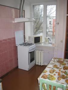 a kitchen with a stove and a microwave at Private apartment in Tallin Kalamaja in Tallinn