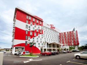 a hotel with cars parked in a parking lot at Tune Hotel - Danga Bay Johor in Johor Bahru