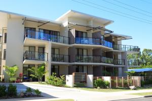 an apartment building with balconies on a street at Agnes Water Beach Club in Agnes Water