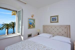 a bedroom with a bed and a large window at Hotel Adriana in Split