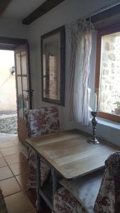 a wooden table in a room with chairs and a window at Stargazer in Saint-Chamassy