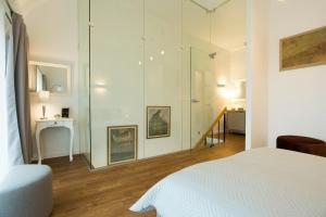 a bedroom with a glass shower and a bed at Relax Birstonas in Birštonas