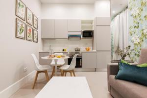 a small kitchen and living room with a table and chairs at Feelathome San Marcos Apartments in Madrid +39 photos