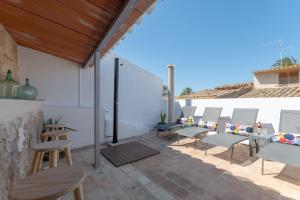 a group of chairs sitting on a patio at YupiHome Holiday Home Ca Na Serrieta in Alcudia