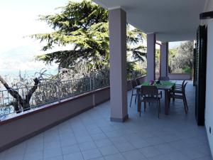 a balcony with a table and chairs and a view at Casa Punta Veleno in Brenzone sul Garda