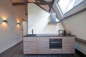 a kitchen with a sink and a stove at Loft Studio's in Zandvoort