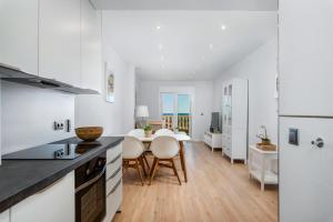 a kitchen and dining room with white cabinets and a table at PENTHOUSE CABO ROIG - ALDEAS I in Orihuela Costa