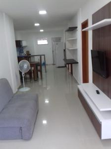 a living room with a couch and a tv at Casa à 500 da Praia in Salinópolis