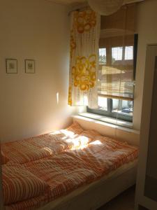 Bett in einem Zimmer mit Fenster in der Unterkunft Białka B in Białogóra
