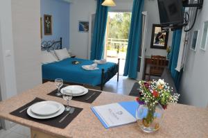 A television and/or entertainment centre at Polymnia Apartments Lassi