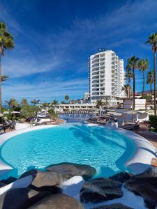 a large swimming pool with a building in the background at H10 Gran Tinerfe - Adults Only in Adeje