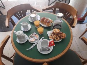 a table with a breakfast of coffee and croissants at La Cibeles in Miramar +14 photos
