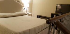 a hotel room with a bed and a television at Art & Jazz Hotel in Catania