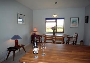 a living room with a table with two wine glasses on it at Dingle Bay View in Dingle