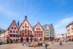 a group of buildings in a city with people at Main Hotel Frankfurt City in Frankfurt/Main