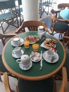 a table with cups and plates of food on it at La Cibeles in Miramar