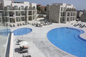 a view of a building with two swimming pools at Amphora Hotel & Suites in Paphos