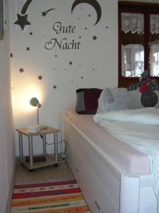 a bedroom with a bed with a moon and stars on the wall at ferienwohnung lispet in Neuötting