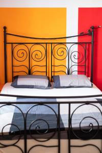 a bed with a black headboard in a room at Fluxus Hostel in Ljubljana