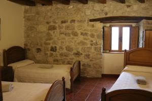 Postel nebo postele na pokoji v ubytování Albergue El Puntido