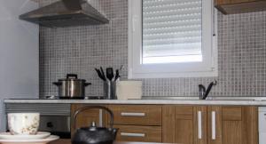 a kitchen counter with a sink and a window at Apartamento El Hechizo Alto in Albacete +6 photos