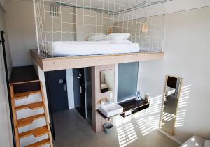 
a bedroom with a bunk bed and a window at Michelberger Hotel in Berlin
