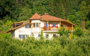 Casa blanca grande con balcón en una colina en Weingut & Apartments Weitgruber Raffeis, en Merano