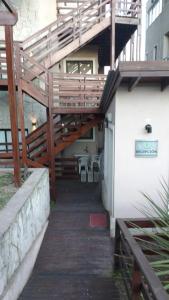 a stairway leading to a building with a wooden deck at Complejo Ayenué & Spa in Ostende