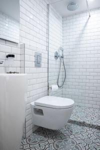 a white bathroom with a toilet and a shower at Dreamyflat - Archives in Paris