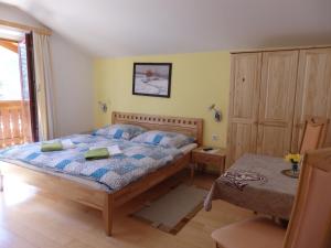 a bedroom with a bed and a table in it at Pension Dagmar Tauplitz in Tauplitz