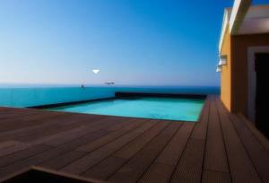 a swimming pool on the deck of a house at La bella vista in Castelsardo