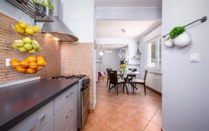 a kitchen and dining room with a brick wall at Apartment Cookie in Pula